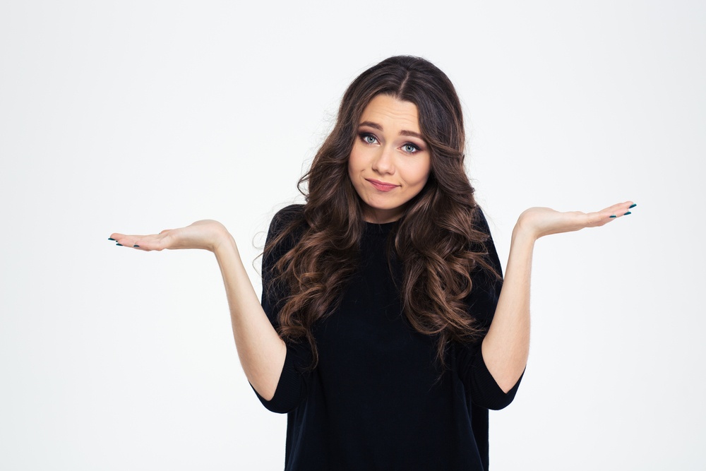 Portrait of a pretty woman shrugging shoulders isolated on a white background-1.jpeg